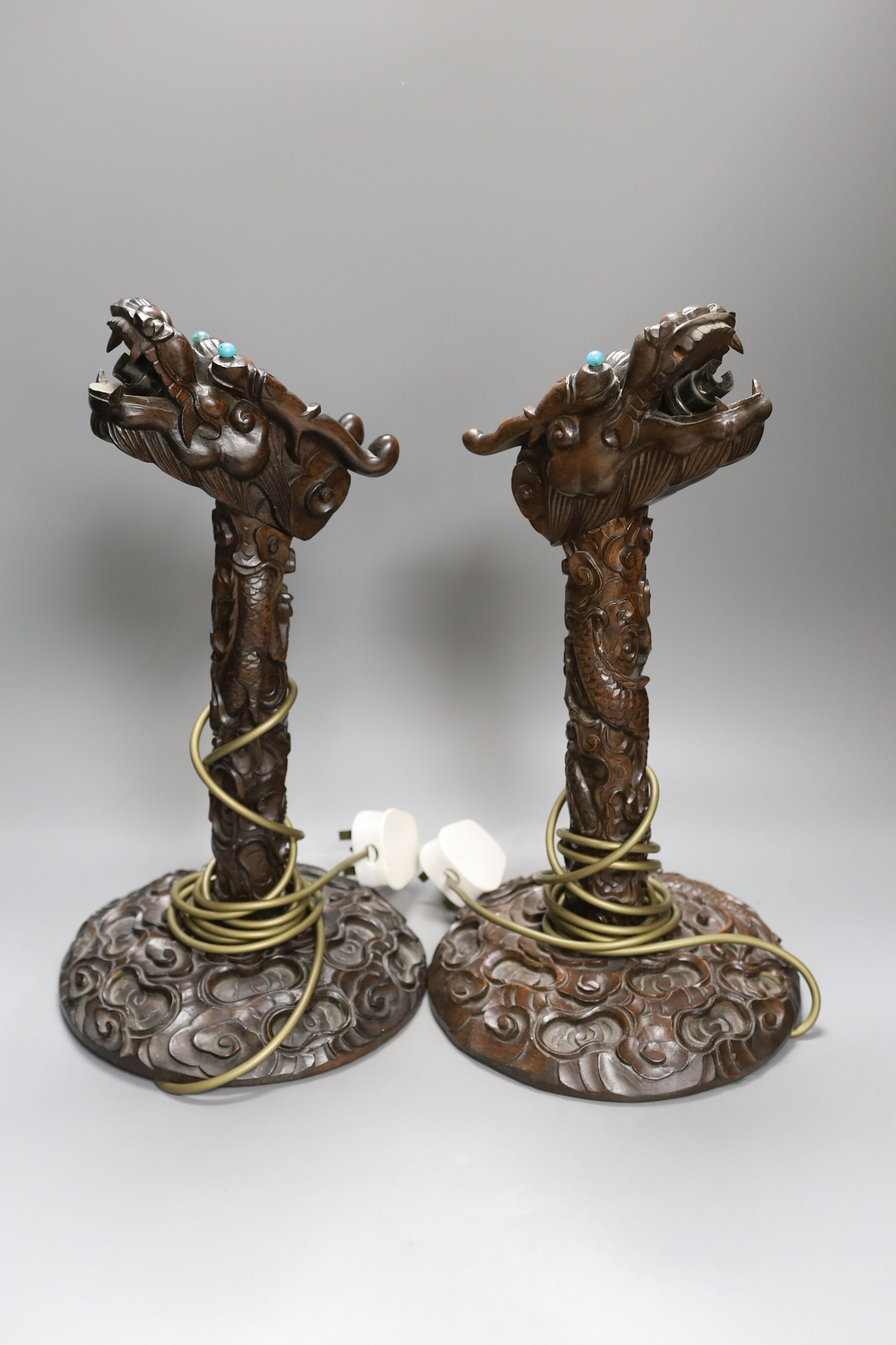 A pair of Chinese carved hongmu dragon lamps - 40cm tall